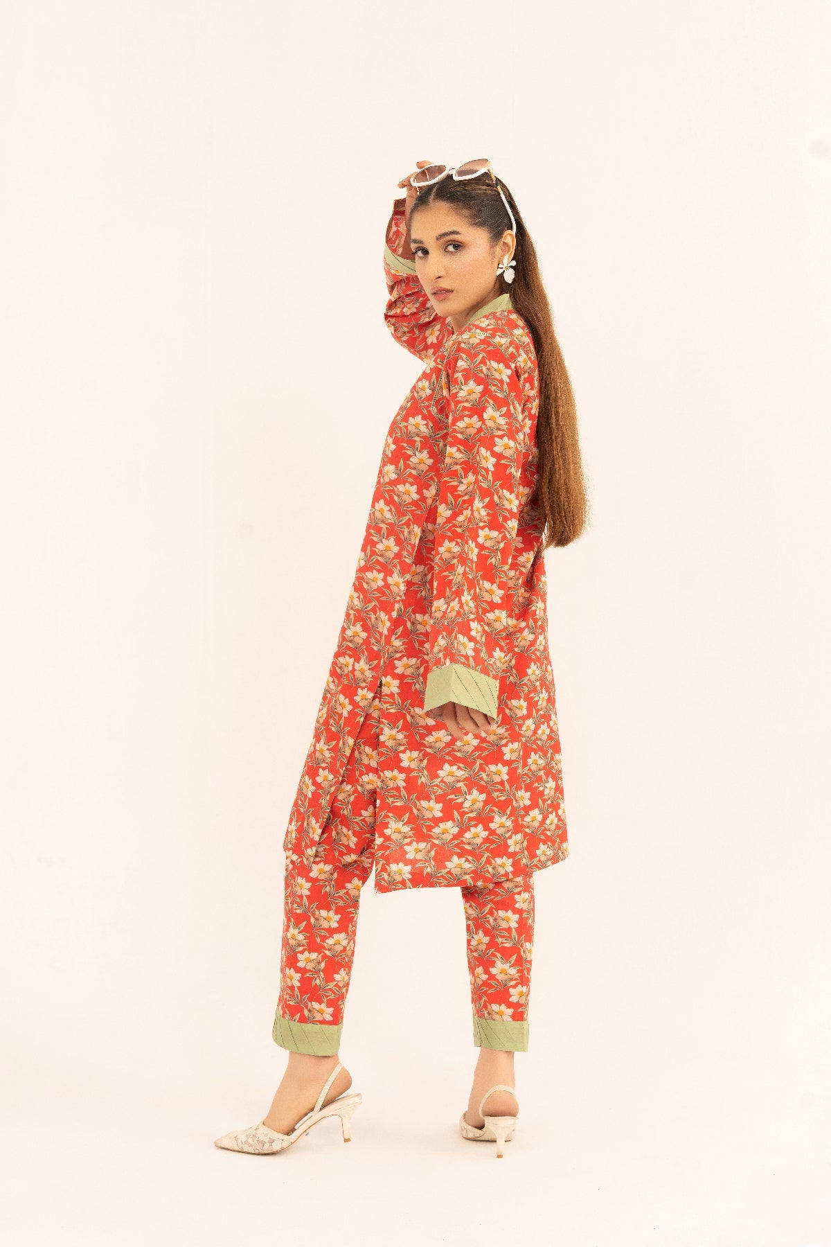 Aroma A-22 digital printed lawn 2 piece suit in red with white floral print and sage green cuffs — angled rear view